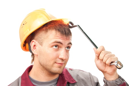 Smilimg working man with wrench. Isolated on white