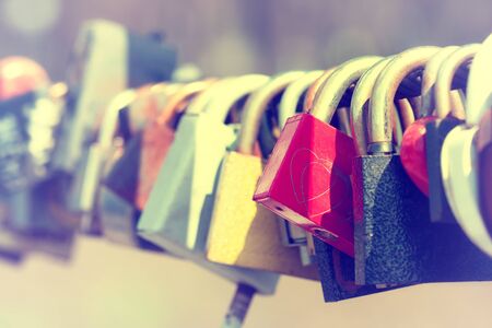 Close-up of padlocks on bridge railingの写真素材