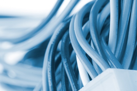 Close-up of electrical plug with cables. Toned in blue