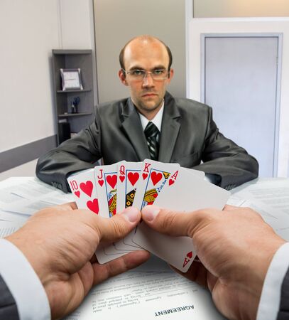 Businessmen playing poker at office