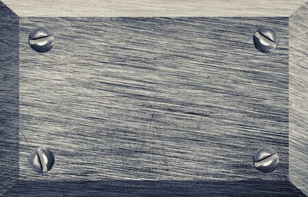 Old scratched metal plaque with screwsの写真素材