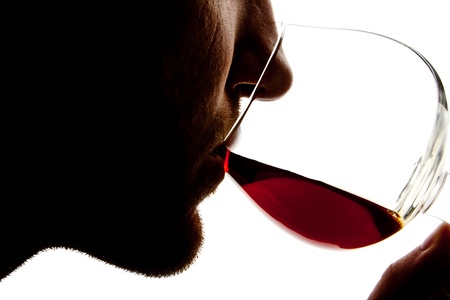 Silhouette of man tasting alcohol. Isolated on whiteの写真素材