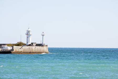 Coastline lighthouse in harbor. Ukraine, Yaltaの写真素材