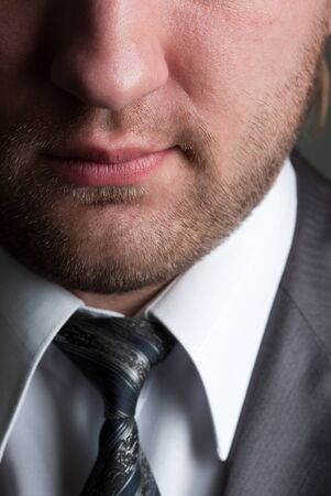 Close-up portrait of serious unshaved businessman in formal wearの写真素材
