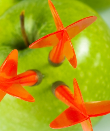 Three red arrows of darts in green apple. Close-upの写真素材