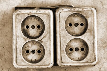 Old dirty electrical outlets on the wall