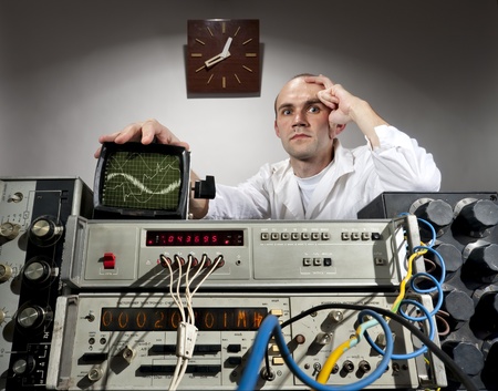 Pensive scientist working at vintage technological laboratoryの写真素材