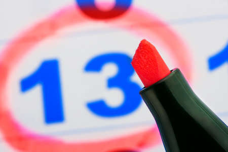 Tip of red marker against calendar pageの写真素材