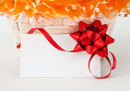 Gift card with ribbon against present basketの写真素材