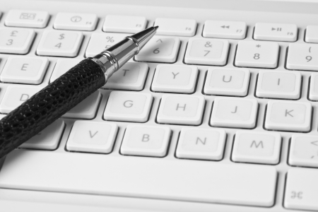 Pen on keyboardの写真素材