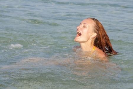 Happy swimming woman in the seaの写真素材