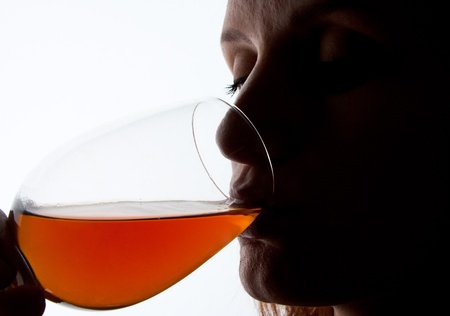 Silhouette of woman degusting wine. Close-up portrait
