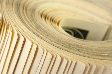 Close-up view of roll of $100 billsの写真素材