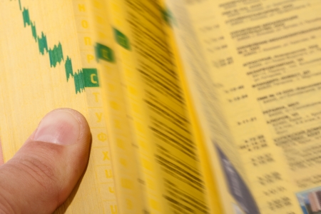 Hand searching the yellow pages with index fingerの写真素材