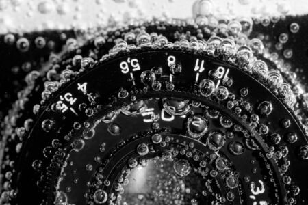 Close-up of old drowned camera under waterの写真素材