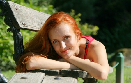 Woman lying on bench in parkの写真素材
