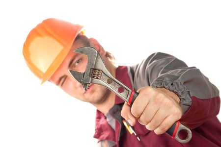 Working man with adjustable wrench. Isolated on whiteの写真素材