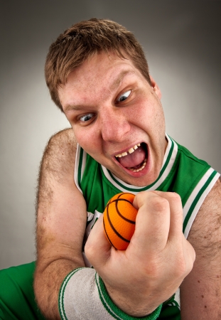 Portrait of bizarre basketball player with small ballの写真素材