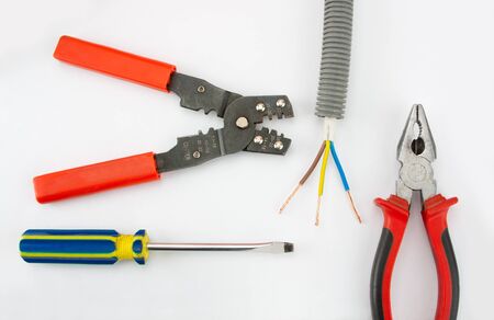 Electrician's tools. Pliers, cable, cutter and screwdriver