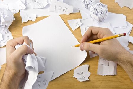 Workspace with crushed paper and hands. Pieces of letter.