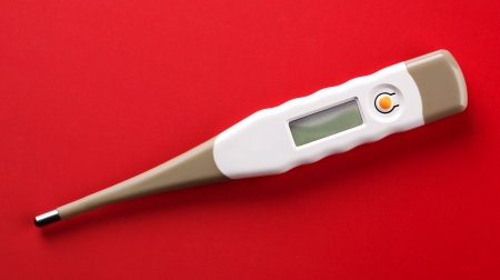 Closeup of digital thermometer on redの写真素材