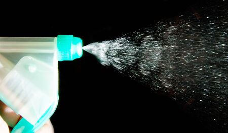 Close-up of splashing plastic water spray bottleの写真素材