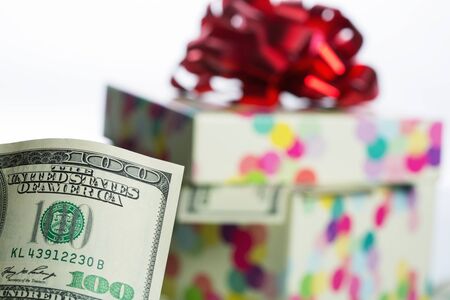 $100 dollar bill against gift boxの写真素材