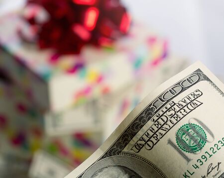 $100 dollar bill against gift boxの写真素材