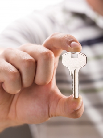 Male hand giving you keyの写真素材