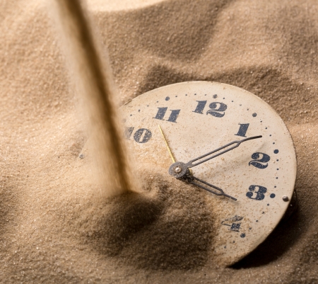 Sand pouring on old clock faceの写真素材