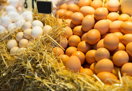 Fresh farm eggs on a straw in marketの写真素材
