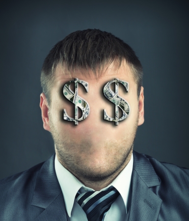 Portrait of faceless businessman with dollar symbols instead of eyesの写真素材