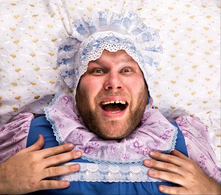 Man weared as baby sleeping with open mouthの写真素材