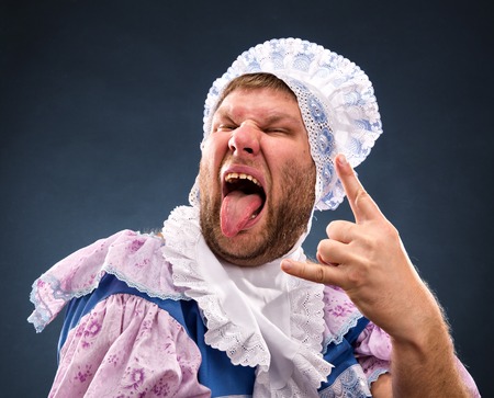Strange man weared as baby sticking out tongueの写真素材
