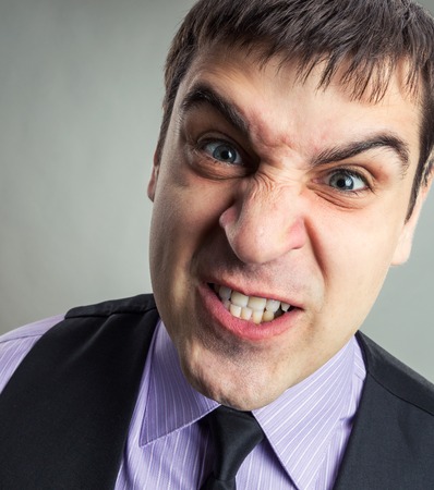 Businessman making faces closeup imageの写真素材
