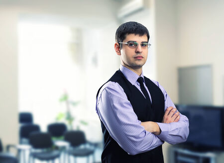 Businessman in modern office looking at youの写真素材