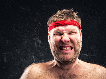 Angry man with red headbandの写真素材