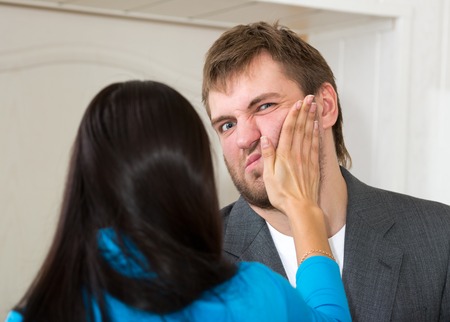 Upset woman slap her partner in living roomの写真素材