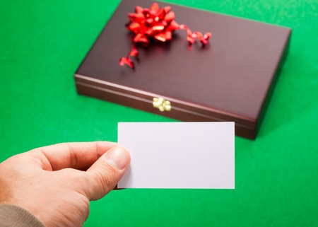 Gift box and blank card in handの写真素材