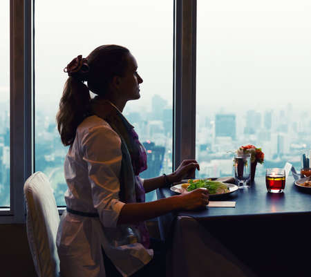 Women sitting in Bangkok cafe aloneの写真素材