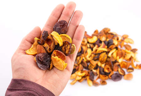 Mix of dried bits of  fruits on the handの写真素材