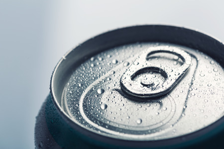 Aluminum can with water drops isolated on gray