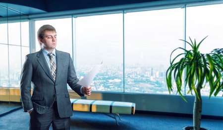 Businessman staying in big light officeの写真素材