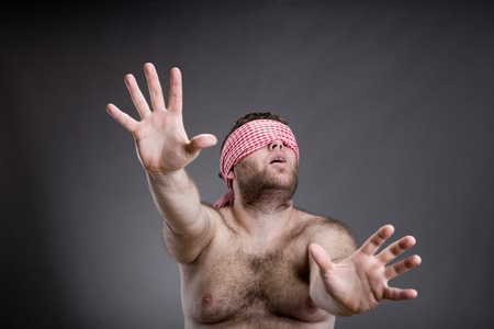 Man playing hide-and-seek , isolated on grayの写真素材