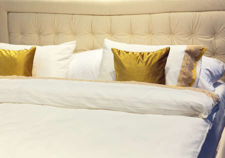 Colorful beautiful pillows on hotel bed in a rowの写真素材