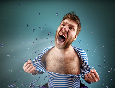 Furious man is tearing clothing on himself and are screaming