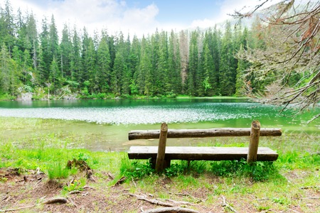 Lake and wooden bench, Durmitor National Park, Montenegroの写真素材