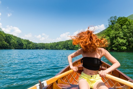 Happy girl in wooden boat. Biograd lake, Montenegro, Europeの写真素材