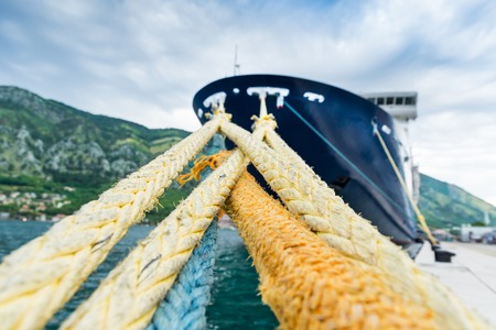Strong ropes is holding a big cruise ship in harborの写真素材