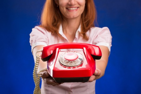 Woman with telephone on blueの写真素材